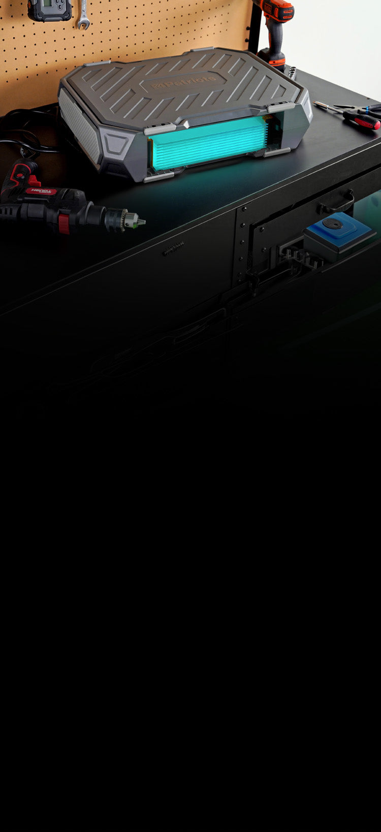 Translation missing: en.Patriot Power Solar Generator AlphaCase Elite on a black garage work table with pegboard tools and drills, solar backup generator