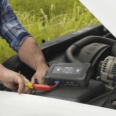 Person jumpstarting their car with product included in the Patriot Power All-in-1 Emergency Car Kit