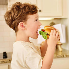 Boy eating a plant-based burger.