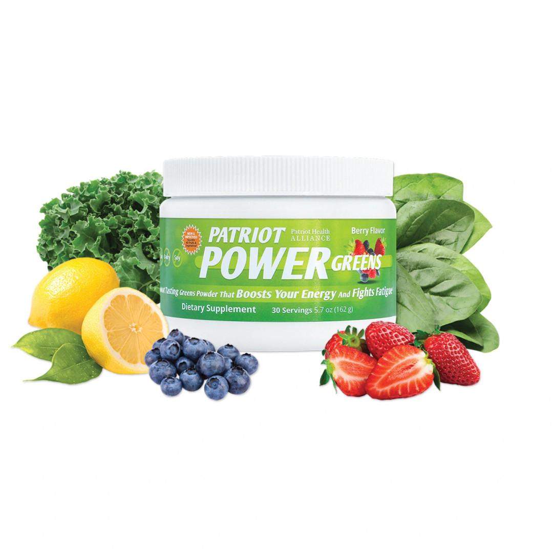 Container of Patriot Power Greens surrounded by fresh fruits and vegetables, including kale, spinach, lemon, blueberries, and strawberries