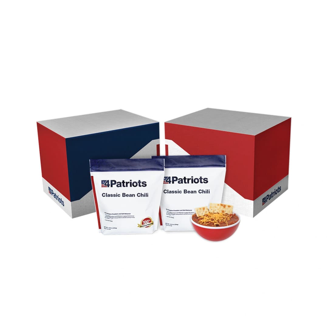 2 pouches of 4Patriots Classic Bean Chili from an emergency survival food kit next to a bowl of cooked Classic Bean Chili topped with crackers and shredded cheese.