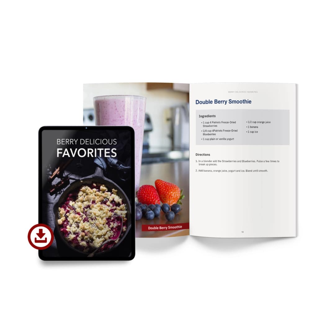 Digital tablet displaying the cover of "Berry Delicious Favorites" next to an open book featuring a Double Berry Smoothie recipe