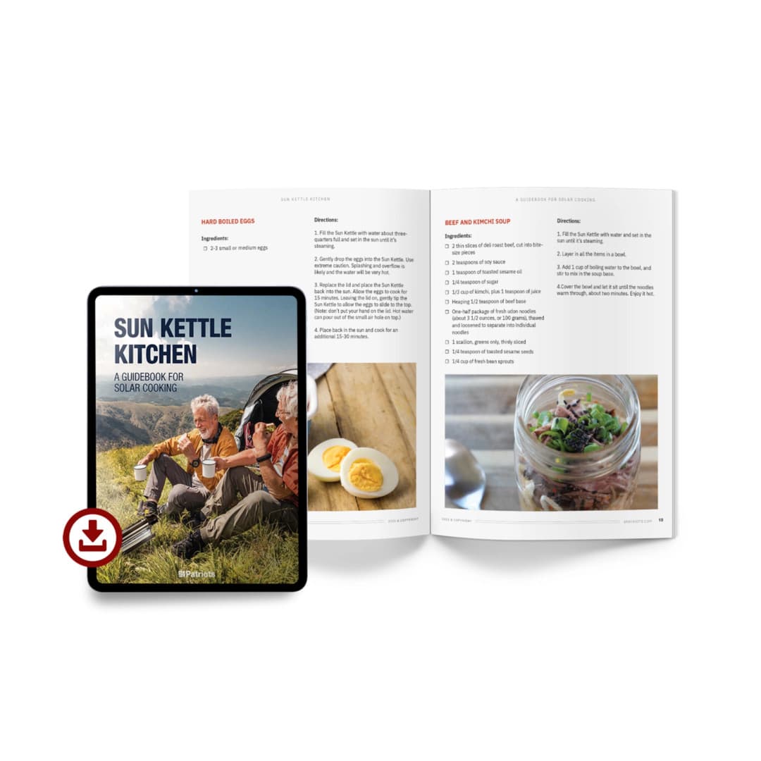 E-book titled "Sun Kettle Kitchen: A Guidebook for Solar Cooking" on a tablet next to an open book with two recipes