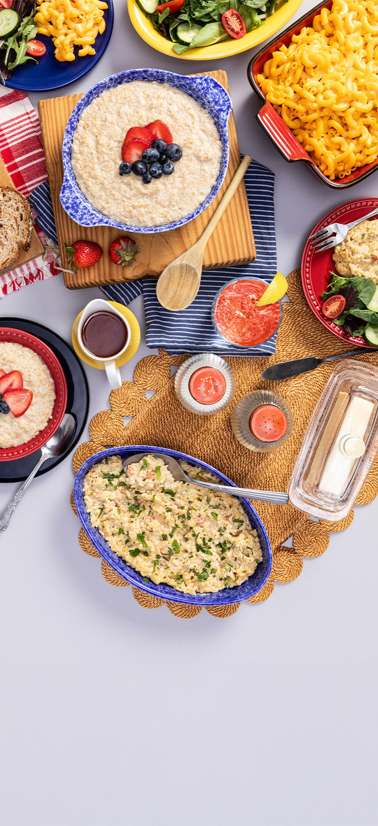 Translation missing: en.2-Week Emergency Survival Food Kit: tall tablescape crop of prepared oatmeal, mac and cheese and creamy rice with salad and a drink, long-term food storage meals