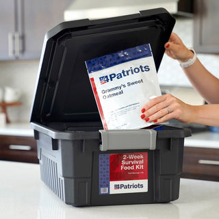 2-Week Emergency Survival Food Kit: woman lifts a 4Patriots Grammy's Sweet Oatmeal pouch from the black storage tote on a kitchen counter, emergency food kit