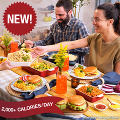 Couple sitting at a table with prepared food. 2,000+ Calories per day.