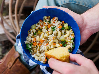 Overhead close-up of a blue bowl of Buckaroo Stew with cornbread, 72-Hour PlatinumXL Emergency Survival Food Kit emergency meals
