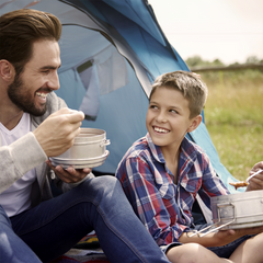 Father and son camping while enjoying their Soups & Stews #10 Can Survival Food Variety Pack.
