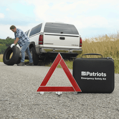 Man changing his tire using the Patriot Power All-in-1 Emergency Car Kit