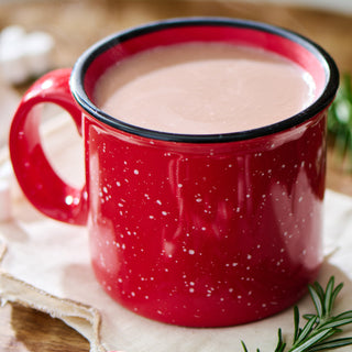 4Patriots Bugle Boy Survival Cocoa Case Pack prepared in a red speckled camp mug of creamy hot cocoa with rosemary garnish, warming survival food drink