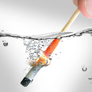FlashFlame Emergency Matches from 4Patriots, a hand holds a lit match underwater by its wooden stick, with the flame burning on the head and bubbles rising around it