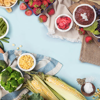 Gold Reserve Emergency Survival Package: Fruit Veggie Snack kit flatlay of broccoli, corn, freeze-dried strawberries and chocolate pudding, survival food