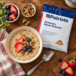 Grammy's Sweet Oatmeal Pouch overhead with a bowl of oatmeal topped with sliced strawberries, blueberries, walnuts and syrup, plus a spoon, emergency food breakfast
