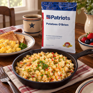 Potatoes O'Brien Pouch behind a cast-iron skillet of diced potatoes and peppers with toast, scrambled eggs and a star coffee mug, survival food breakfast