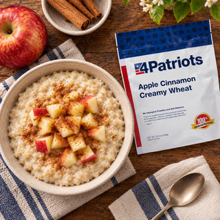 Apple Cinnamon Cream of Wheat Pouch overhead next to a bowl of hot cereal with diced apple, a red apple and cinnamon sticks, survival food breakfast