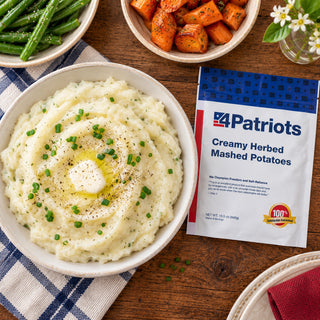 Creamy Herbed Mashed Potatoes Pouch overhead beside a bowl of mashed potatoes with melting butter, chives and pepper, green beans and roasted carrots, survival food side