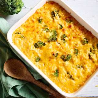 Dinner Bell Broccoli Bake Pouch shown beside a baking dish of cheesy broccoli and rice casserole with fresh broccoli, hearty emergency food meal
