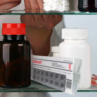 IOSAT Potassium Iodide Tablets 130mg package stored on a medicine cabinet shelf alongside other supplement bottles, demonstrating compact, easy storage