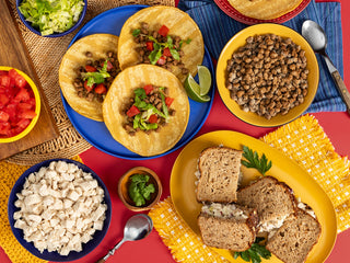 Gold Medallion All-Meat Emergency Survival Kit flatlay of tacos, sandwiches and bowls of freeze-dried beef and chicken, showing everything included for long-term food storage