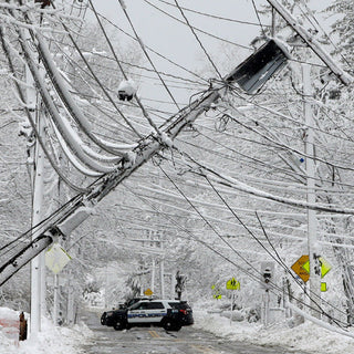 Downed power lines and a police car after a snowstorm, the winter emergency a Meat & Protein Deluxe Emergency Survival Food Kit is stored for