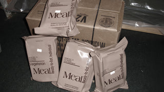 Military Meal, Ready-to-Eat MRE pouches including vegetarian manicotti, pot roast and chicken tetrazzini beside their case, emergency ready-to-eat rations for disaster preparedness