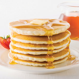 4Patriots Buttermilk Pancake Mix #10 Can made into a tall stack of golden pancakes with butter, syrup and a strawberry, hearty survival food breakfast