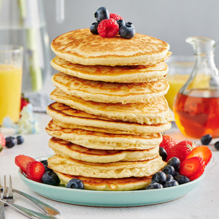 4Patriots Buttermilk Pancake Mix #10 Can served as a berry-topped pancake stack with syrup and orange juice on a breakfast table, tasty survival food