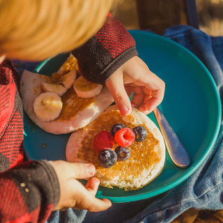 4Patriots Buttermilk Pancake Mix #10 Can served as fluffy pancakes topped with berries as a child reaches for a bite outdoors, easy survival food breakfast