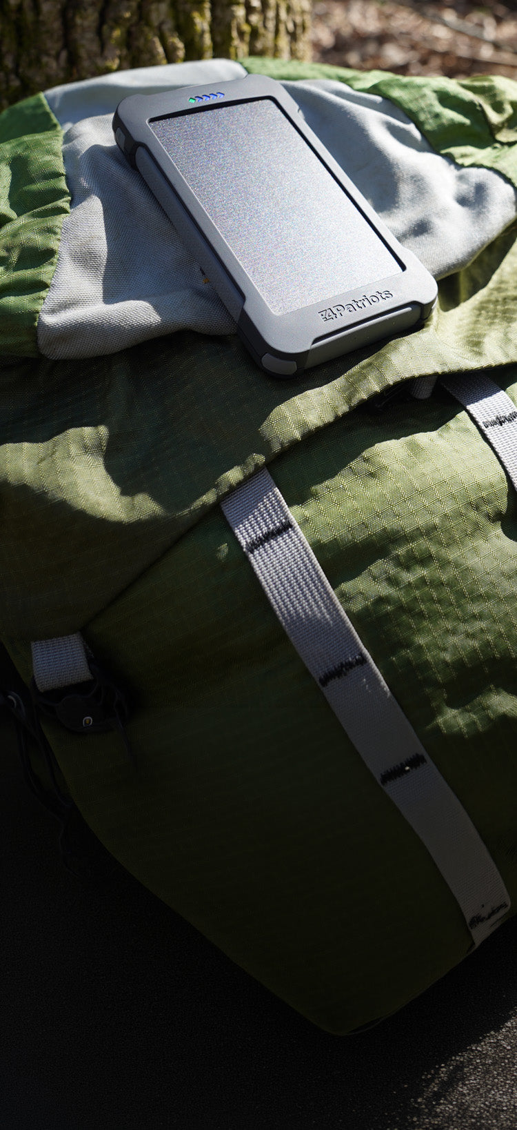 Translation missing: en.Patriot Power Cell-CX Portable Solar Power Bank specifications chart, backpack-in-woods setting, detailing capacity, USB ports, size and off-grid solar charging specs
