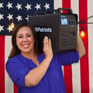 Smiling woman holds the Patriot Power Solar Generator 1800 portable solar power station on her shoulder against an American flag for emergency backup power