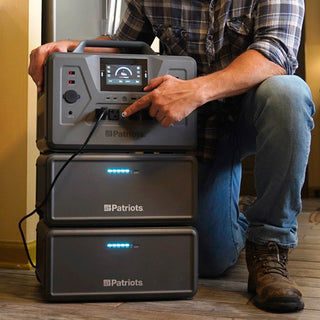 Expansion Battery Pack for Patriot Power Generator 2200X, close-up of two stacked packs and the 2200X as a man plugs in his refrigerator for emergency backup power
