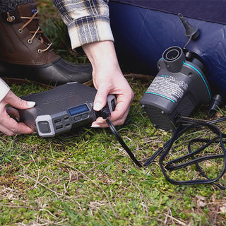 Patriot Power Voyager XL Solar Power Bank powering an electric pump to inflate a camp air mattress, portable off-grid battery charger for outdoor and emergency use
