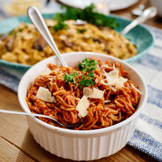 Nonna's Secret Recipe Spaghetti from the Pasta Lovers Survival Food Kit topped with parmesan shavings at the table