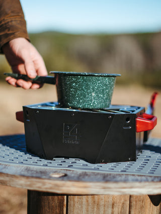 RescueHeat Emergency Space Heater & Stove boiling water in a pot outdoors, a portable off-grid cook stove for emergency preparedness during power outages