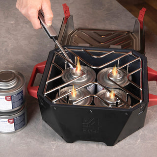 Lighting the four fuel cans inside the RescueHeat Emergency Space Heater & Stove on a kitchen counter, an indoor emergency heater and stove for power outage preparedness