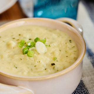 Cozy Potato Soup from the Comfort Classics Survival Food Kit, a creamy bowl garnished with fresh chopped scallions
