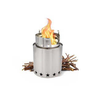 StarFire Portable Camp Stove single unit, a stainless steel wood- and twig-burning camp stove with flames beside a pile of kindling for off-grid and emergency cooking