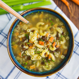 Soups & Stews Variety #10 Can shown as a prepared bowl of Fireside Stew with pasta, lentils and carrots in broth, hearty survival food