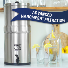 4Patriots Ultimate Water Filtration System on a counter next to clean filtered water with 