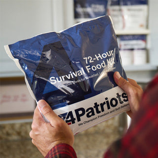 72-Hour Survival Food Kit held by a man in a kitchen with stocked shelves behind, 4Patriots emergency food for long-term food storage and disaster preparedness