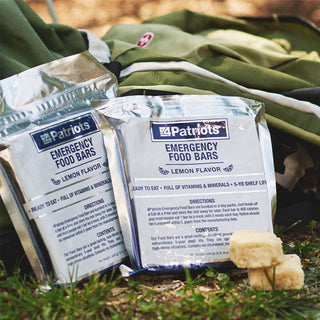 Emergency Food Bars: two 4Patriots Emergency Food Bars Lemon Flavor multi-packs by a backpack outdoors, buy-one-get-one survival food for long-term food storage and disaster preparedness