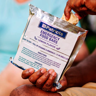 Emergency Food Bars: hand holds a 4Patriots Emergency Food Bars Lemon Flavor pack, ready-to-eat emergency food and survival food with 5-year shelf life for disaster preparedness