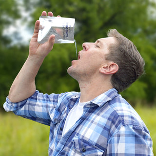 Emergency Drinking Water Pouches - 3-Day Supply being poured into a man's mouth outdoors, easy-to-drink emergency drinking water on the go
