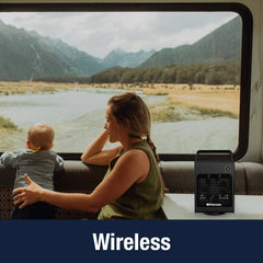 Woman and baby sitting in an RV with the Breezy cube portable air cooler