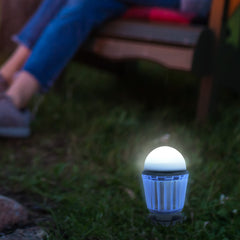 SunBuzz Solar Mosquito Lantern next to a person sitting in a chair outside.