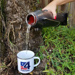 Pouring hot water from the Sun Kettle® Solar Cooker into a mug