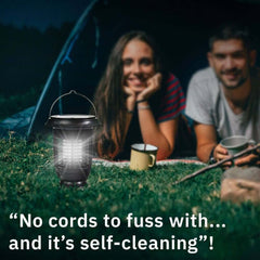 Man and women in a tent next to the BugOUT Solar Lantern. No cords to fuss with... and it's self-cleaning.
