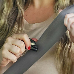 Person using the 4Patriots car escape tool to cut a seatbelt