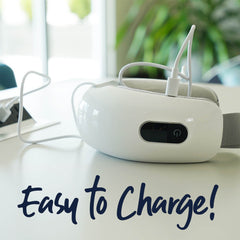 Personal eye massager charging on a table. Easy to charge!