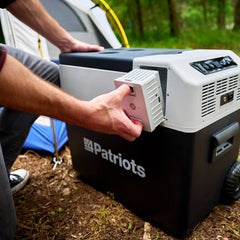 Go-fridge battery being placed in the solar go-fridge at a campsite